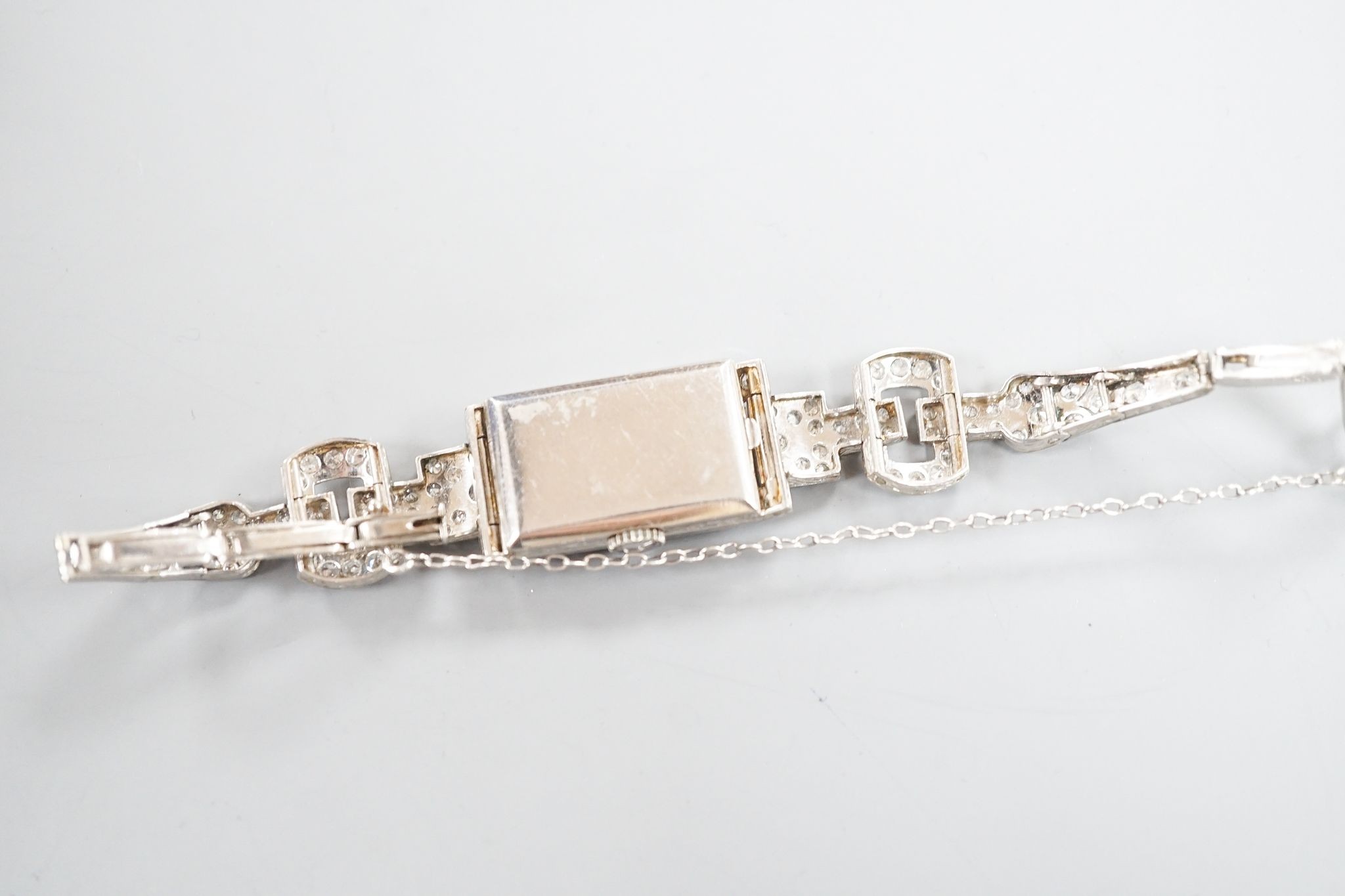 A lady's white metal (stamped platinum) and diamond set cocktail watch, the bracelet with diamond set shoulders, approx. 16cm, gross weight 23.8 grams.